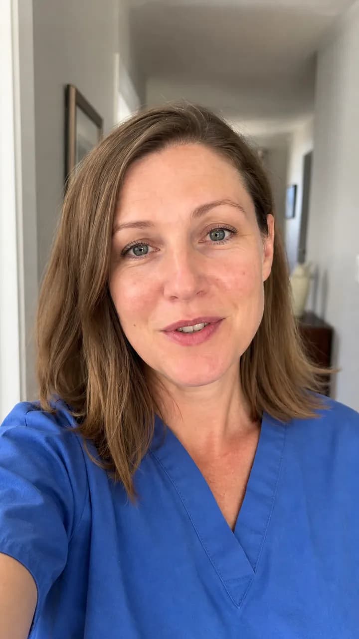 Ingrid S. in scrubs speaking calmly to camera in a home hallway