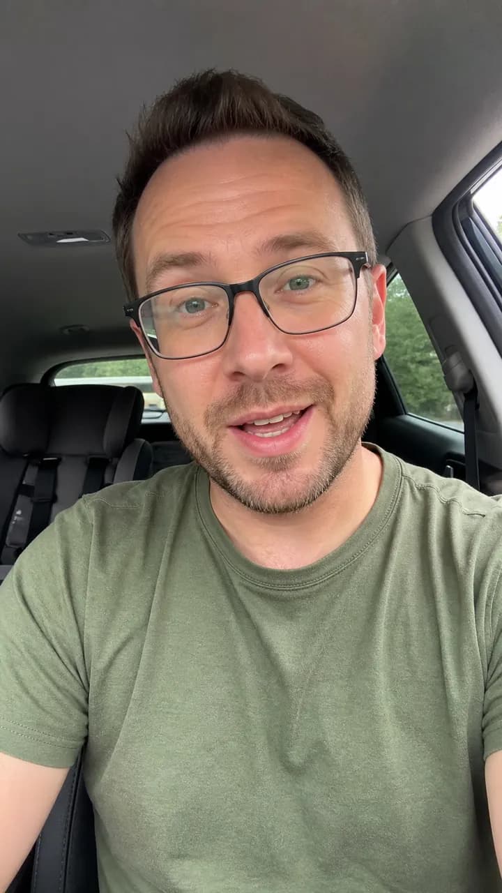 Oliver P. talking cheerfully to camera in a parked family car